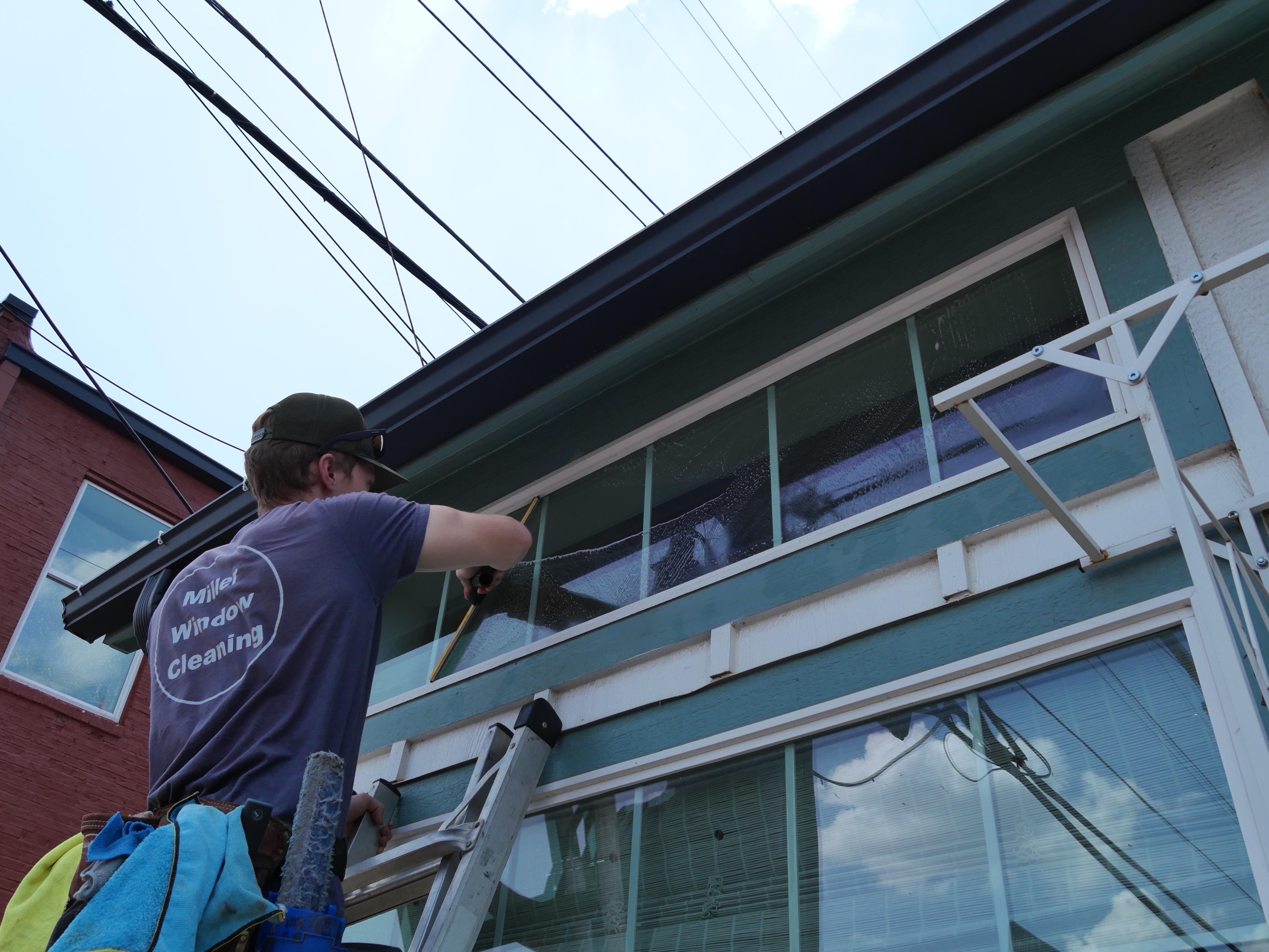 Josh Miller working on a window cleaning job